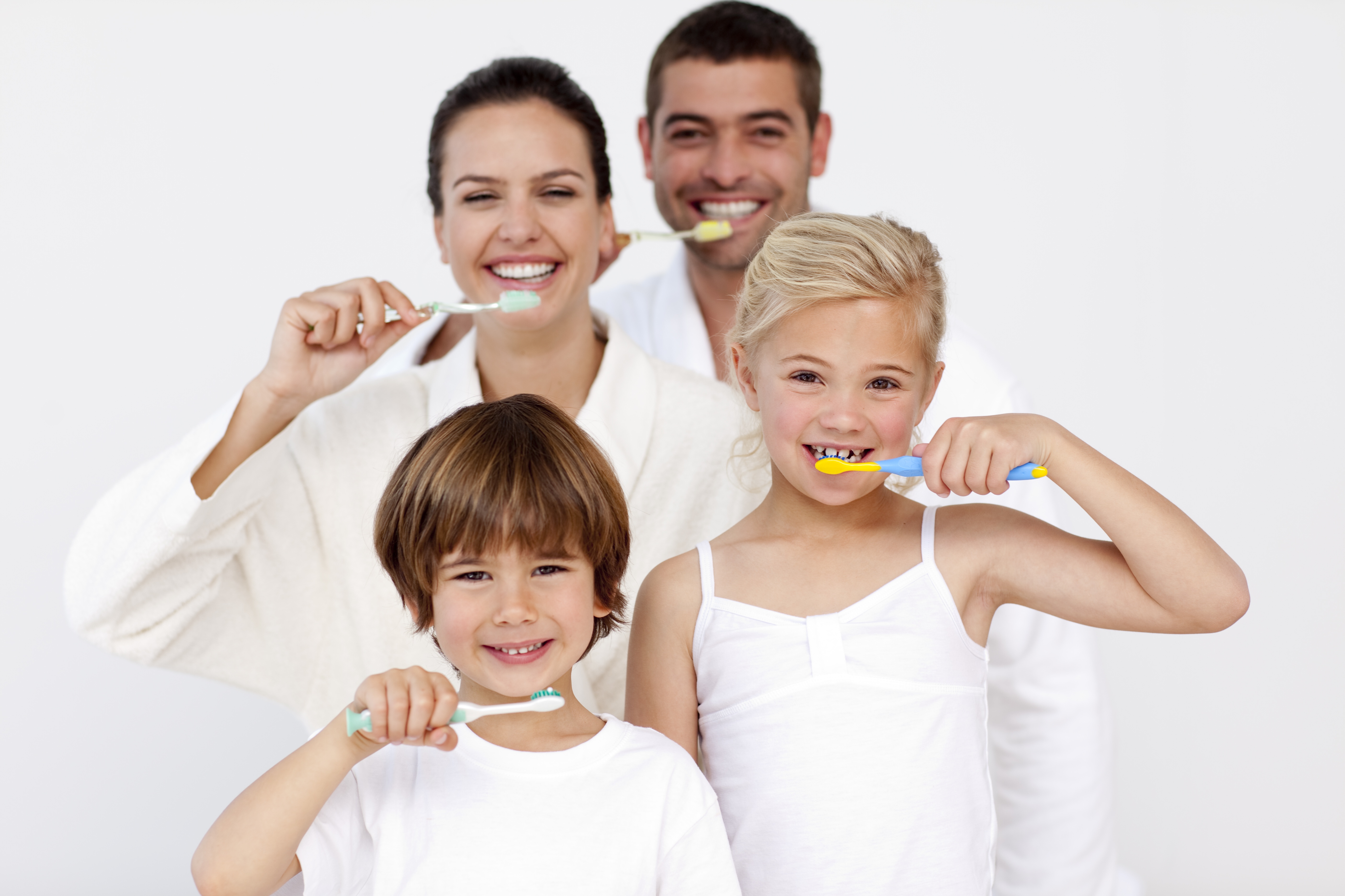 Family smiling and brusing teeth