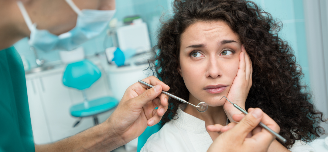 Woman with a toothache visiting a dentist to see if it could be a cavity.