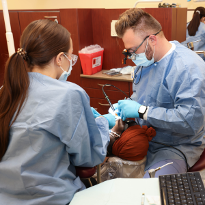 Two residents work on a patient